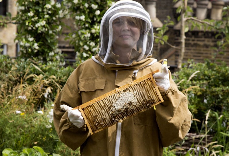 Ham Yard's own dedicated bee keeper Camilla in full gear in the leafy Roof Terrace kitchen garden.