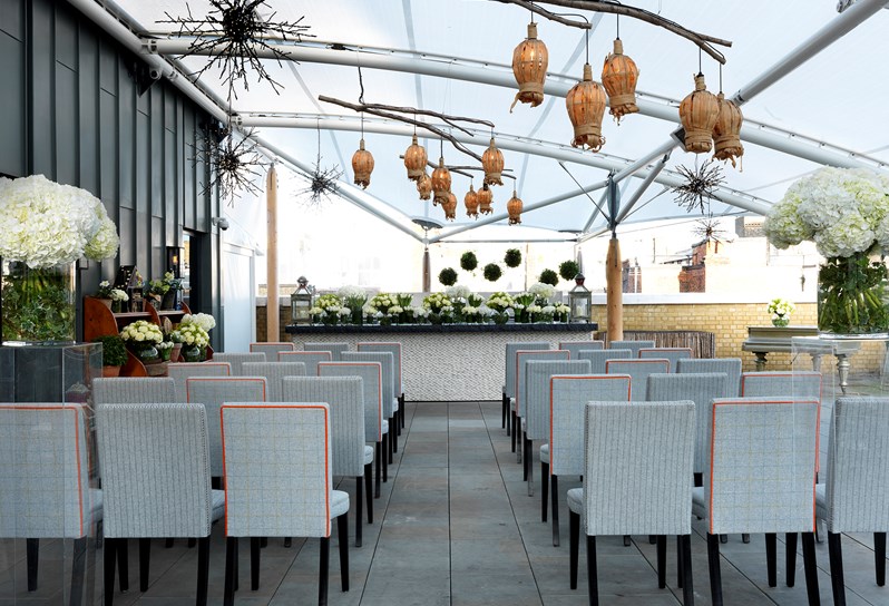 The Ham Yard Roof terrace set up for a wedding with rows of chairs facing forward.