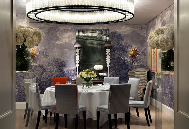 The Windmill room with grey graphic wallpaper and large white table laid up for a formal dinner
