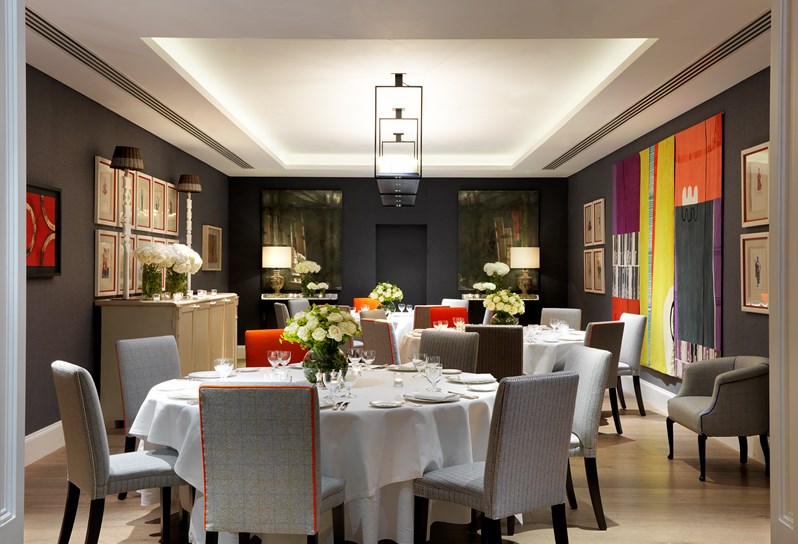 The Sherwood room set up with several large white tables laid up for a formal dinner