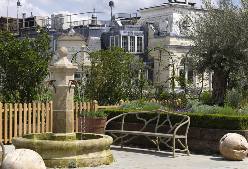 Ham Yard Hotel roof gardens featuring a stone water fountain