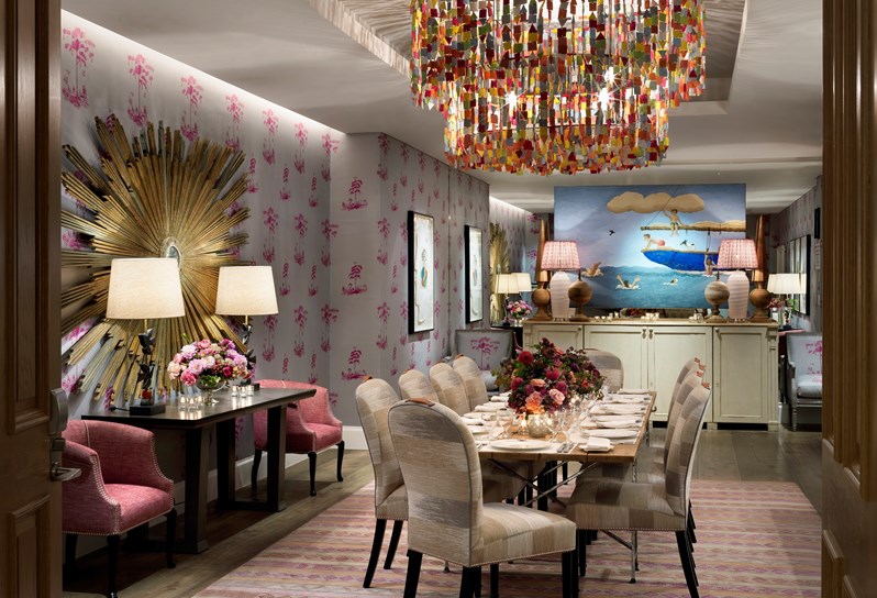 Spring Private event room has colourful linen walls with a beautifully set long tables and chairs, fresh flowers and spectacular overhead ceiling lights.