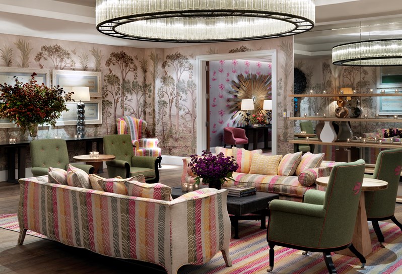 Prince Private event room has colourful linen walls with a beautiful sofas and and chairs, fresh flowers and spectacular overhead ceiling lights.