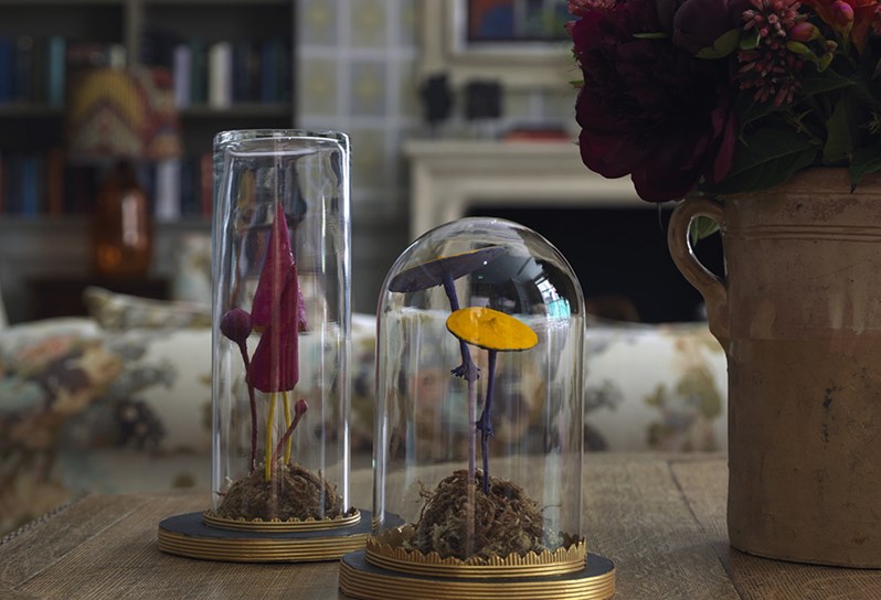 Quirky artwork in form of colorful mushrooms encapsulated in glass goblets placed on the entrance table in the Library at Ham Yard Hotel.