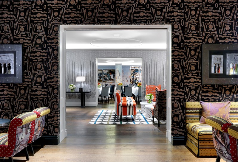 The Crimson Bar event room opens into the Sandra Blow event room to connect to one large event space. Walls are covered in detailed dark fabrics