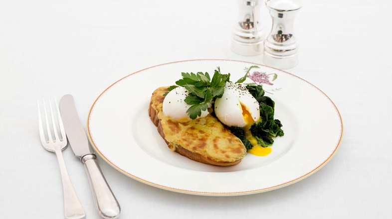 Two poached eggs on a slice of Welsh rarebit with stewed spinach