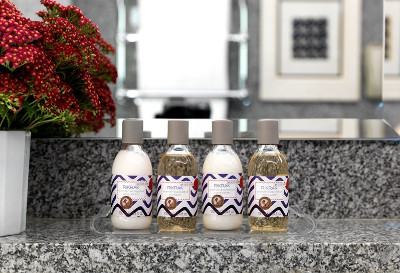 Kit Kemp's own range of Lavender Eucalyptus RikRak bathroom products in a granite bathroom.