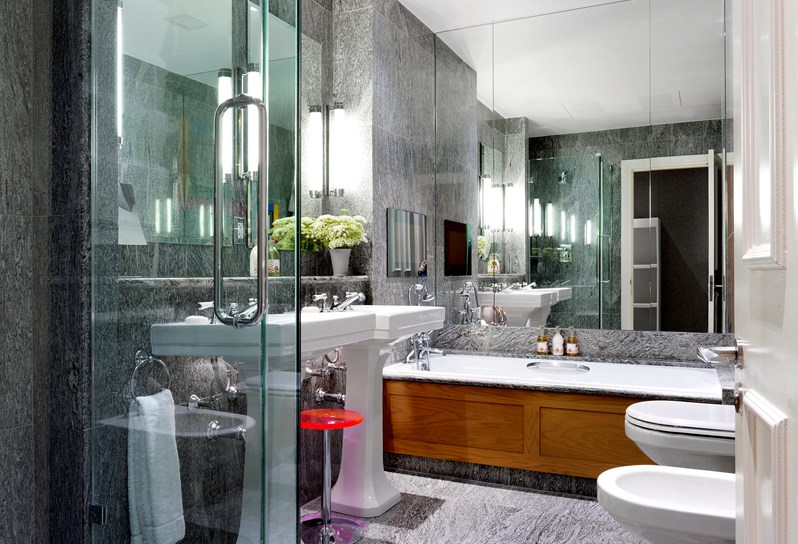 A beautiful granite bathroom at with two basins and RikRak by Kit Kemp bath products.