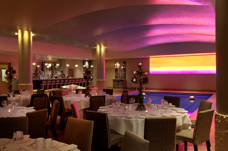 Diagonal shot of round dining tables in the Swimming pool private events room at Haymarket Hotel