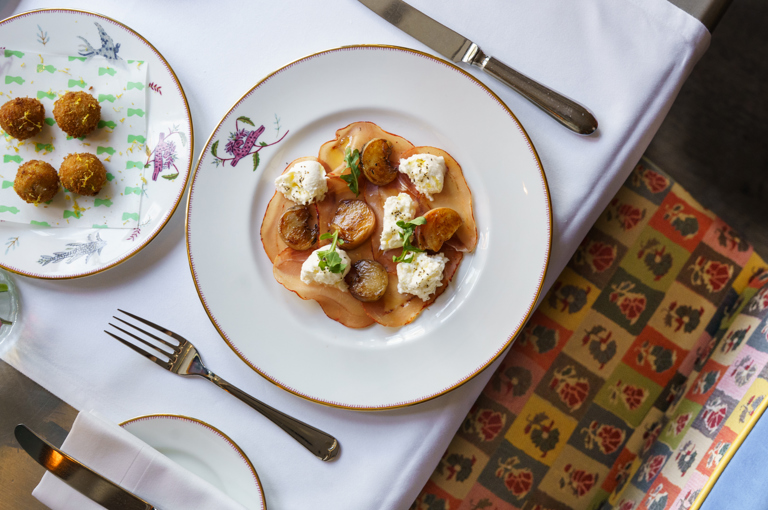 An image of the appetisers Bruschetta with burrata, mortadella and pistachios on Mythical Creatures crockery from Autumn A La Carte at Oscar, Charlotte Street hotel