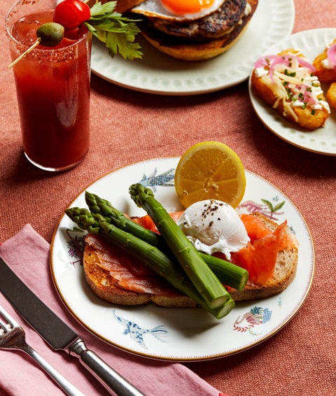 An image of the Mary Fitzrovia cocktail and Enderby smoked salmon with poached egg and asparagus to promote Weekend Brunch at Oscar, Charlotte Street Hotel.