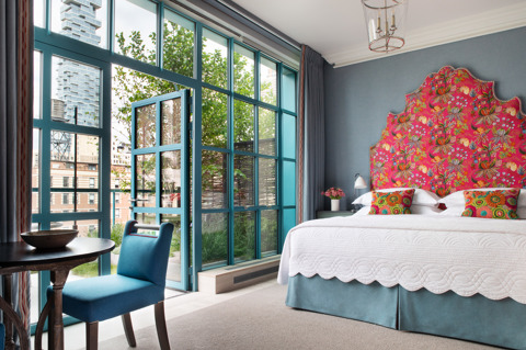 Diagonal shot of Junior Terrace Suite, 906 looking out onto the terrace at Warren Street Hotel