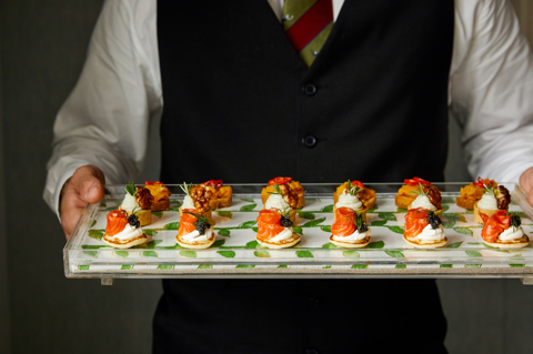 Close shot of Firmdale waiter holding Festive canapés
