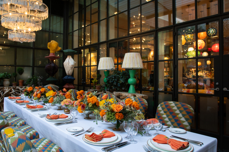 Image of a long table set up for lunch in The Orangery at Crosby Street Hotel.  