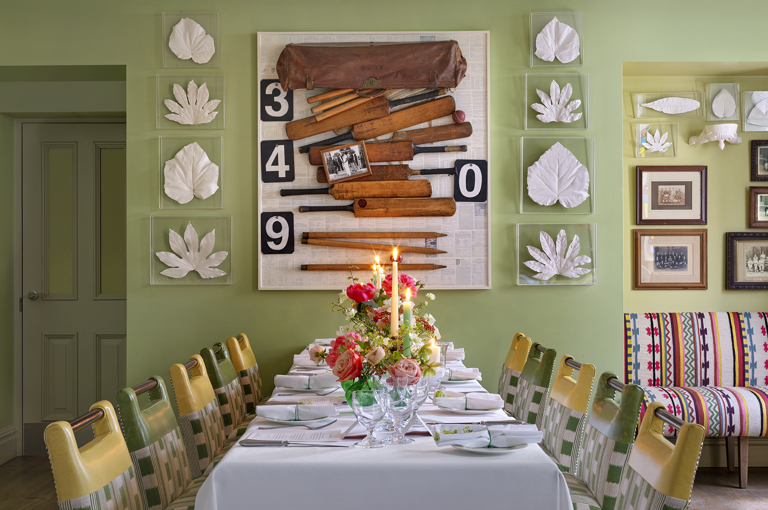 A table is set for a wedding celebration with flowers and candles in The Potting Shed at Dorset Square Hotel