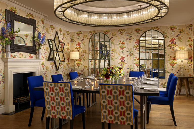 Squared dining table set-up with dim lighting in the Fortune private events room at Covent Garden Hotel
