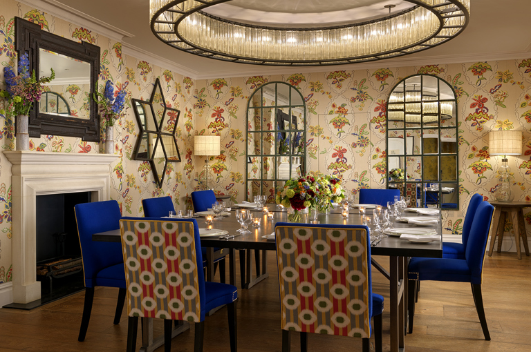 Squared dining table set-up with dim lighting in the Fortune private events room at Covent Garden Hotel
