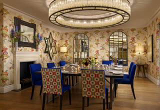 Squared dining table set-up with dim lighting in the Fortune private events room at Covent Garden Hotel