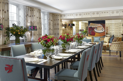 Day shot of a long dining table in the Rocklin private events room at Haymarket Hotel