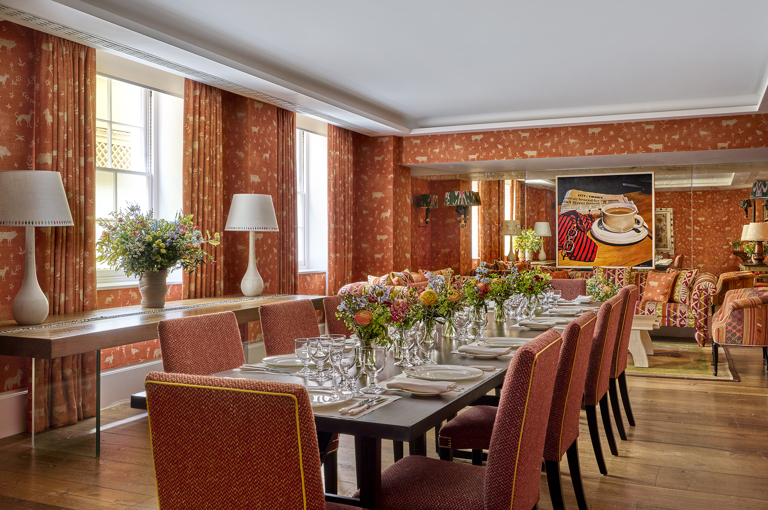 Day shot of a long dining table in the Rocklin private events room at Haymarket Hotel