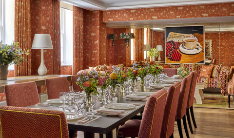 Day shot of a long dining table in the Rocklin private events room at Haymarket Hotel