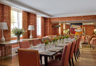 Day shot of a long dining table in the Rocklin private events room at Haymarket Hotel