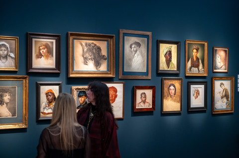 This image is of the inside the fair at frieze, in it we can see people looking at the art collections within the fair. this is being used to promote Ham Yards restaurant pop up with the art fair. 