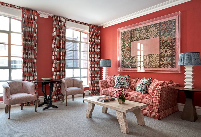 The sitting area of a Connecting Junior Suite, with a sofa, coffee table and two arm chairs.