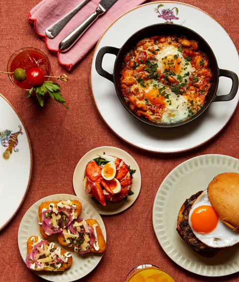 Multiple dishes from The Weekend Brunch menu at Oscar, Charlotte street Hotel. Including Shaksuka, loaded hash browns, the McOscar Muffin, Toasted chocolate and hazelnut brioche and lobster toasted crumpets with soft boiled quail’s eggs.