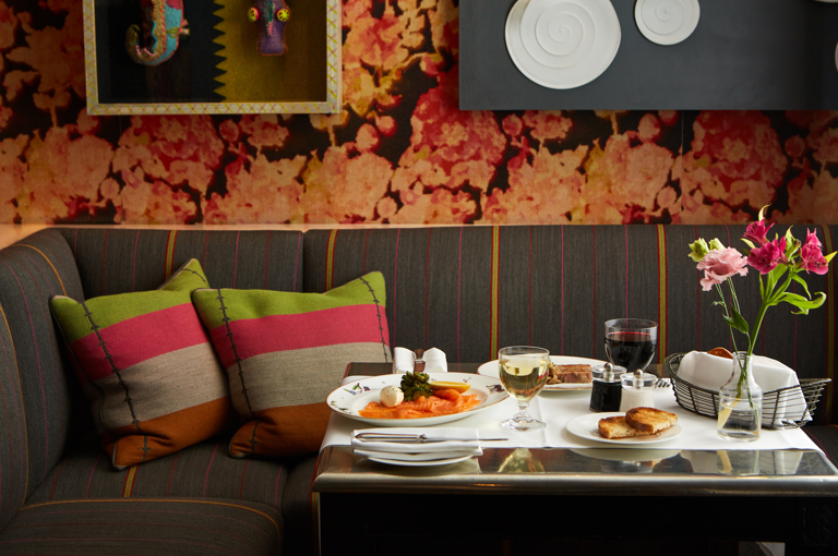 A wide shot of a table at Refuel with starters of smoked salmon and terrine
