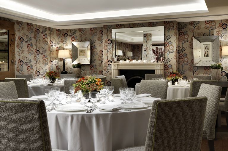 Round dining tables set-up in the Duncan Grant private events room at Charlotte Street Hotel