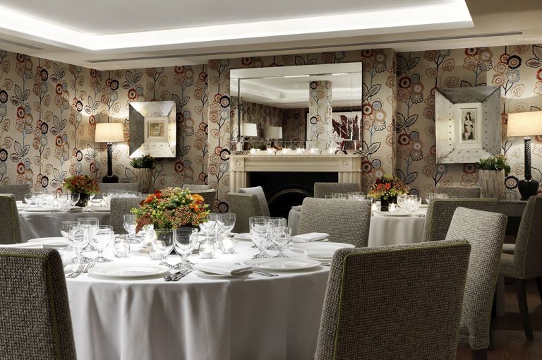 Round dining tables set-up in the Duncan Grant private events room at Charlotte Street Hotel