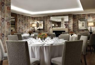 Round dining tables set-up in the Duncan Grant private events room at Charlotte Street Hotel