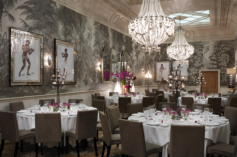 Round dining tables in the Shooting Gallery private events room at Haymarket Hotel