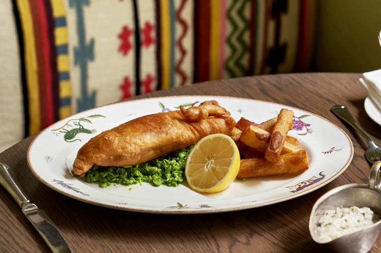 Close up shot of a main course of fish and chips with tartare sauce on a plate at The Potting Shed