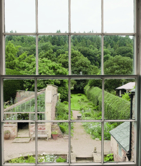 An image to promote Harriet Thystlethwaytes new book 'A country style: living and creating with nature through the seasons'. The image shows a view over Harriet's garden through a window.