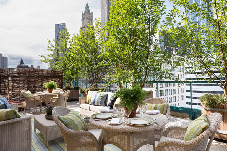 Wide shot of dining tables and lounge area on the Rooftop Terrace at Warren Street Hotel