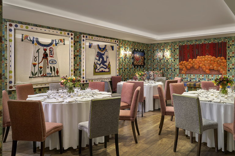 A round dining tables set-up in the Vanessa Bell private events room at Charlotte Street Hotel