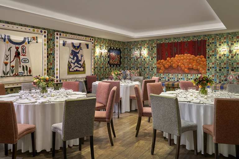 A round dining tables set-up in the Vanessa Bell private events room at Charlotte Street Hotel