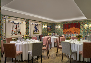 A round dining tables set-up in the Vanessa Bell private events room at Charlotte Street Hotel