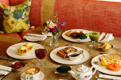 An image of multiple dishes from the breakfast menu including the Brioche French toast with caramelised banana, pecans and maple syrup and Oscar Benedict with crispy bacon and crushed avocado at Oscar, Charlotte Street Hotel.