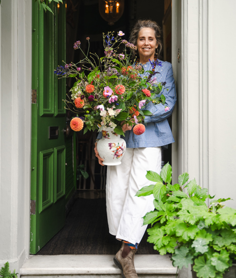 A shot of Butter Wakefield, garden designer, holding a bouquet of flowers