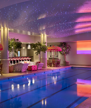 A diagonal shot of the swimming pool and bar at Haymarket Hotel looking across to the pool bar area