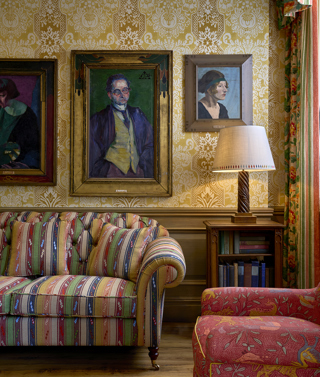 Paintings hang above a patterned sofa at Charlotte Street Hotel
