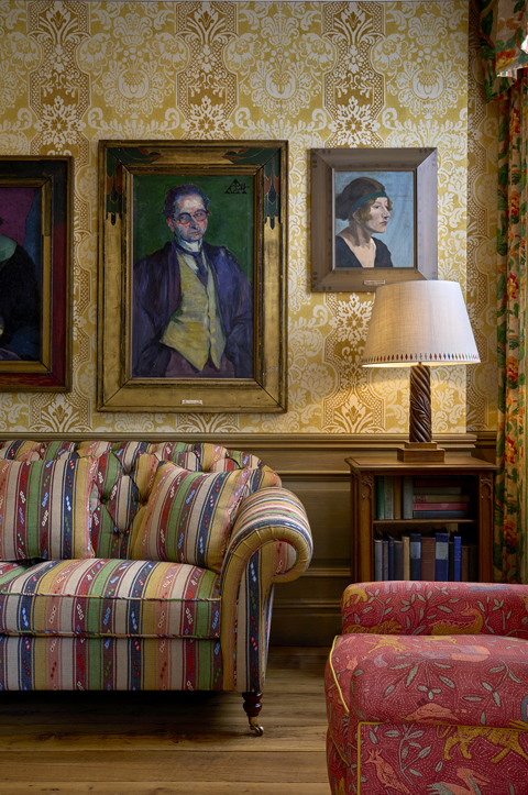 Paintings hang above a patterned sofa at Charlotte Street Hotel