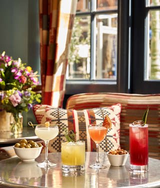 Wide portrait shot of cocktails and bar snacks at Oscar