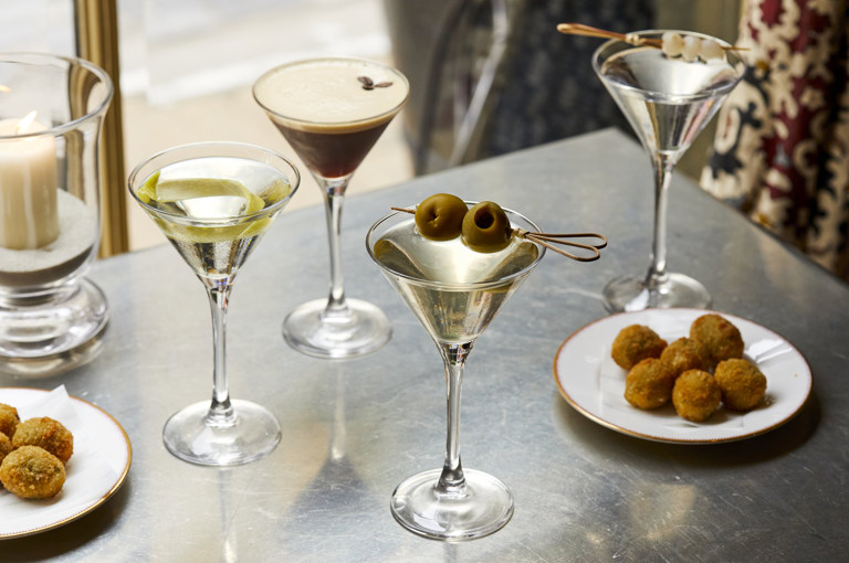 Wide shot of Martinis and bar snacks on a bar table at Brasserie Max