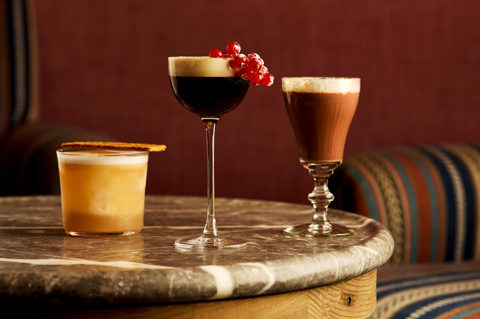 Three festive cocktails at Brumus. An espresso martini with red berries, a hot chocolate cocktail and a short ginger cocktail