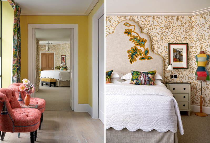 A yellow hallway with two small coral chairs leading to a bedroom with walls decorated in a textured fabric with a yellow leaf pattern and a large bed with a decorative headboard