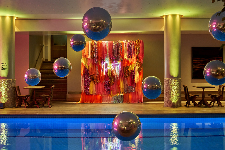 Side shot of large balloons above the Swimming pool private events room at Haymarket Hotel